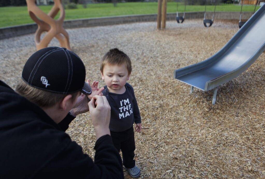 Petaluma, CA, USA. Tuesday, December 06, 2016._Josh, a Petaluma resident, removes splinters his son, Jax, 2, received while playing at Arroyo Park. A 30-year-old play structure there is slated for replacement. (CRISSY PASCUAL/ARGUS-COURIER STAFF)
