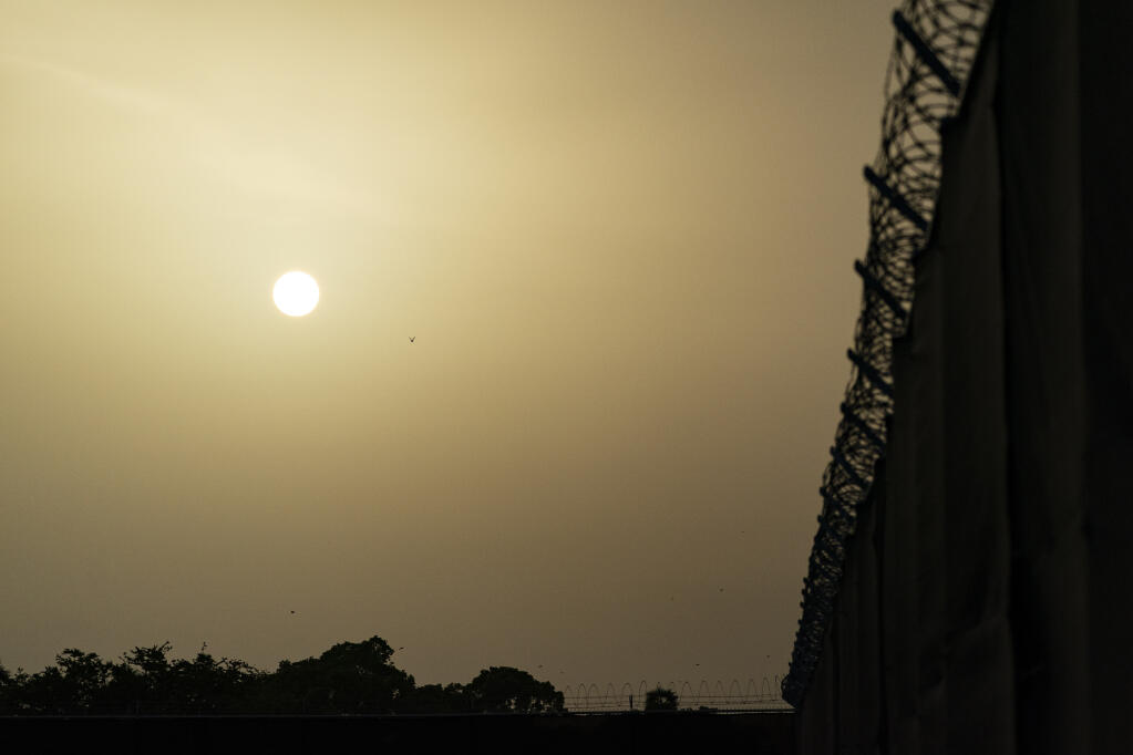FILE - In this Aug. 29, 2021, file photo reviewed by U.S. military officials, the sun sets as seen from Camp Justice in Guantanamo Bay Naval Base, Cuba. (AP Photo/Alex Brandon, File)