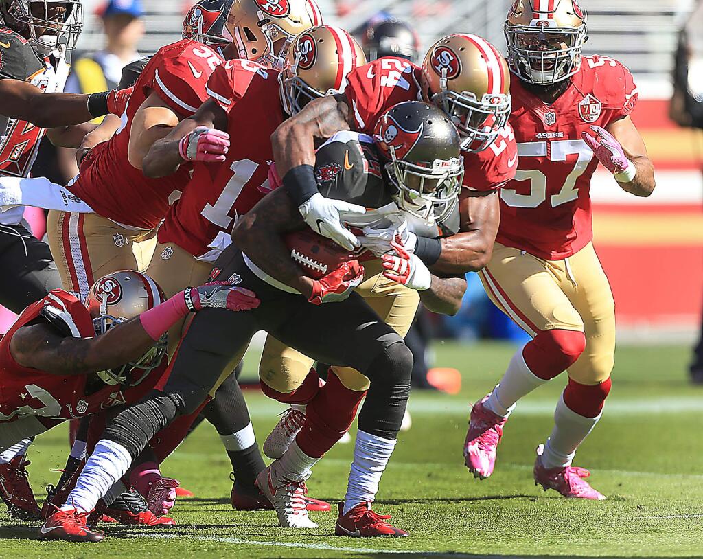 The 49ers defense has a hard time taking down Tampa Bay ball carrier Ryan Smith at Levi's Stadium in Santa Clara, Sunday Oct. 23, 2016. (Kent Porter / The Press Democrat) 2016