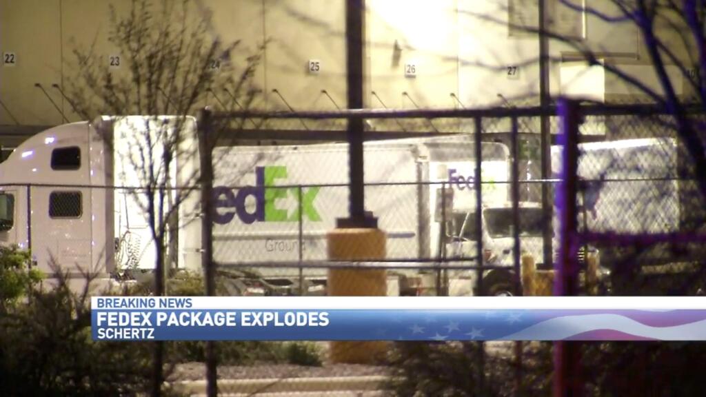 In this frame from video, Fedex trucks line a distribution center where a package bomb exploded early, Tuesday, March 20, 2018, in Schertz, Texas. Authorities believe the explosion is linked to the recent string of Austin bombings. (WOAI San Antonio via AP)