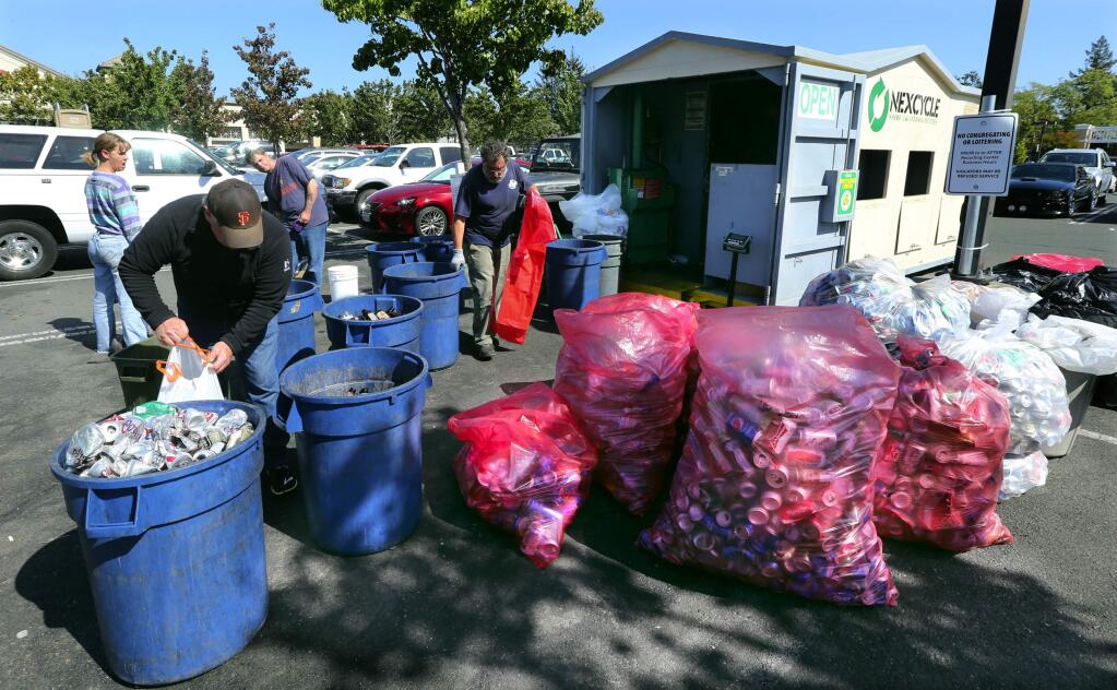 Customers bring their recycling to the Nexcycle redemption station in the Mendocino Ave. Safeway parking lot on Tuesday morning. (JOHN BURGESS / The Press Democrat)