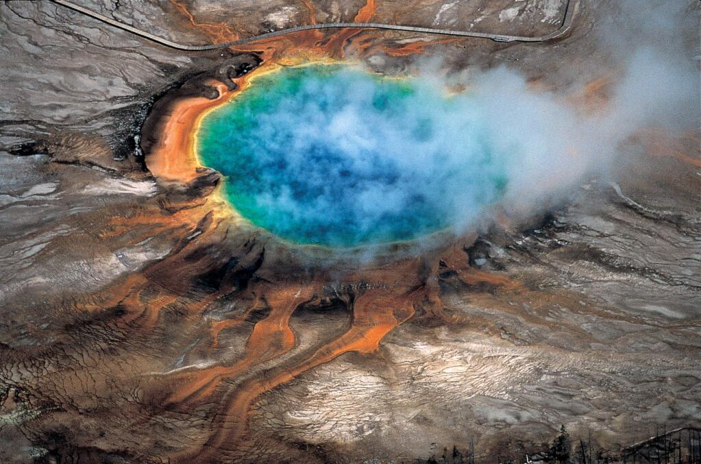 This undated photo provided by Robert B. Smith shows the Grand Prismatic hot spring in Yellowstone National Park's that is among the park's myriad hydrothermal features created by the fact that Yellowstone is a supervolcano, the largest type of volcano on Earth. Scientists have discovered a new, deeper reservoir of partly molten rock beneath the Yellowstone supervolcano. But they said the find doesnt change the chances of a volcanic eruption. (Robert B. Smith via AP)
