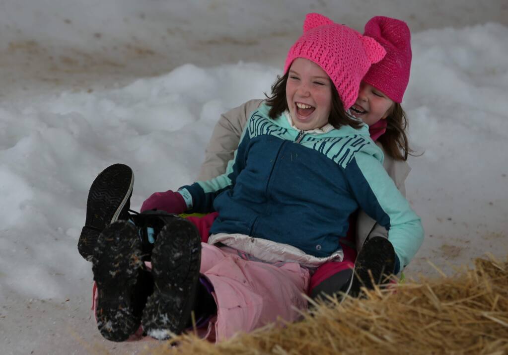 Friends Rhen Sweet, 8, front, and Anna Benbow, 5, go sledding during the Snow Days event at the Children's Museum of Sonoma County on Sunday, January 20, 2019 in Santa Rosa, California . (BETH SCHLANKER/The Press Democrat)