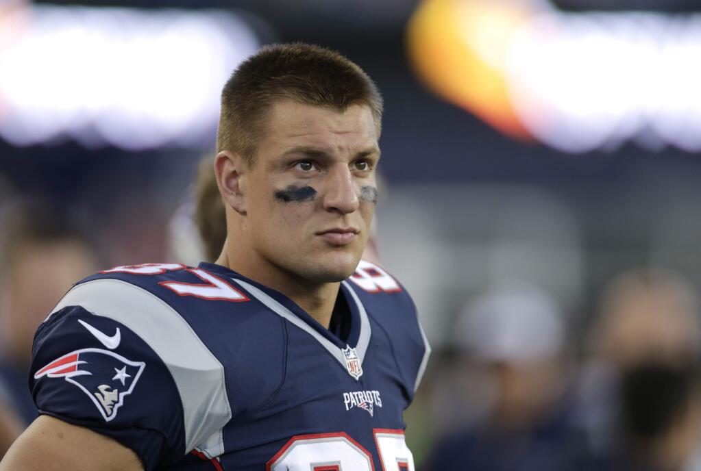 FILE - In this Thursday, Aug. 13, 2015 file photo, New England Patriots tight end Rob Gronkowski (87) watches from the sideline during an NFL preseason football game in Foxborough, Mass. If you managed to stay awake in school when teachers talked about economics, you might remember the term ìopportunity cost.î Put simply, it describes what you couldíve bought had you chosen to spend your money differently. Consider Rob Gronkowski the touchdown-scoring embodiment of that in fantasy football. (AP Photo/Charles Krupa, File)