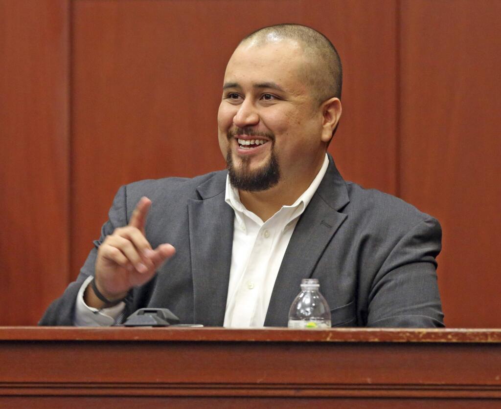 FILE- In this Sept. 13, 2016 file photo, George Zimmerman smiles as he testifies in a Seminole County courtroom in Orlando, Fla. Zimmerman, who was acquitted of the 2012 killing of an unarmed black teen Trayvon Martin, has filed a lawsuit, Wednesday, Dec. 4, 2019, against the teens' parents, family attorney and prosecutors who tried his case, claiming they coached a witness to give false testimony. (Red Huber/Orlando Sentinel via AP, Pool, File)
