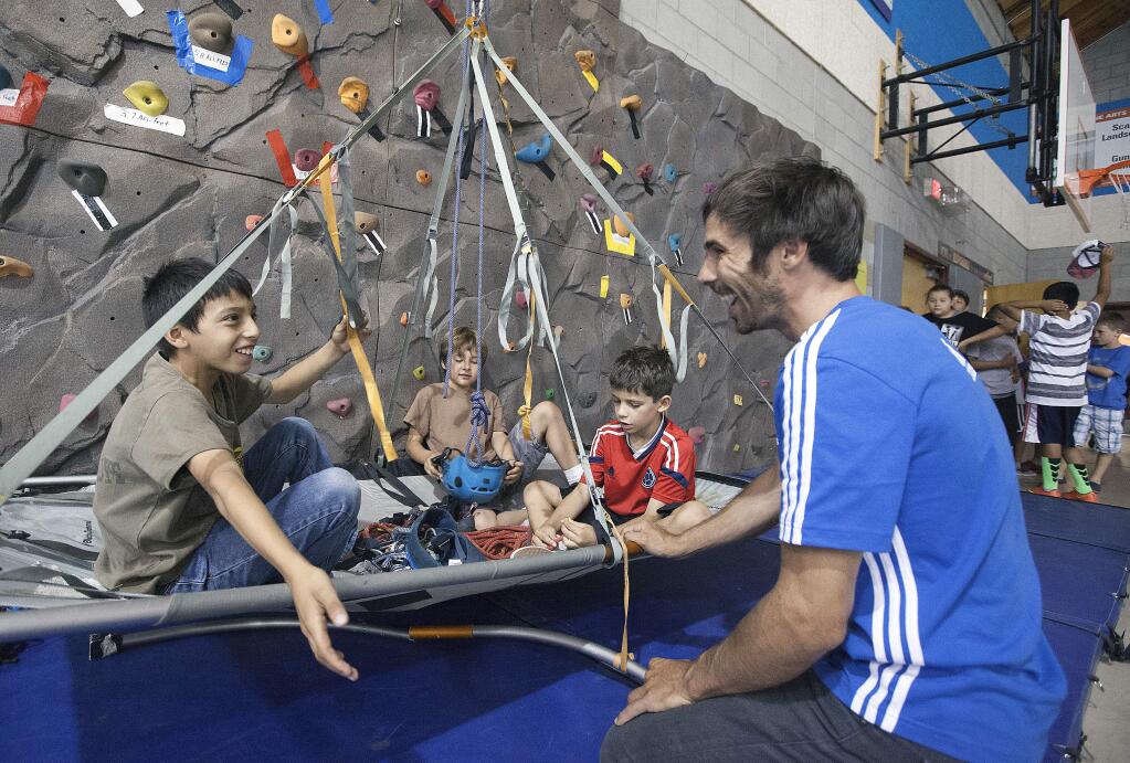 Kevin Jorgeson, who recently completed a historic ascent of El Capitan's Dawn wall in Yosemite National Park, visited the Boys and Girls Clubs of Sonoma Valley last Friday. Club members, in groups of two or three, were invited to experience the PortaLedge, a system designed for sleeping thousand of feet off the ground, and to ask one question of the rock star. (Photos by Robbi Pengelly/Index-Tribune)