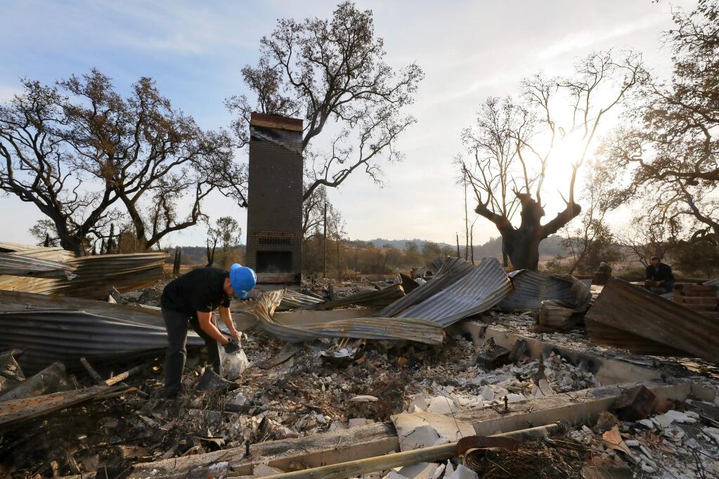 Max Yourman, of Patriot Environmental Laboratory Services, Inc., collects debris samples for hazardous waste profiling, which is the first step in the debris removal process, at the main house on the Newman ranch property near Calistoga on Monday, November 11, 2019. Six residences on the property were destroyed by the recent Kincade fire.(Christopher Chung/ The Press Democrat)