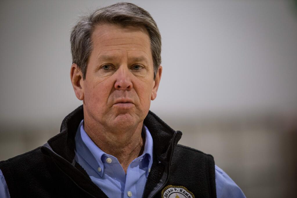 Georgia Gov. Brian Kemp listens to a question from the press during a tour of a massive temporary hospital at the Georgia World Congress Center on Thursday, April 16, 2020, in Atlanta. Kemp took part in a tour of the 200-bed facility, constructed quickly in the lower levels of the Georgia World Congress Center which normally plays host to large conventions and sporting events. (AP Photo/Ron Harris, Pool)