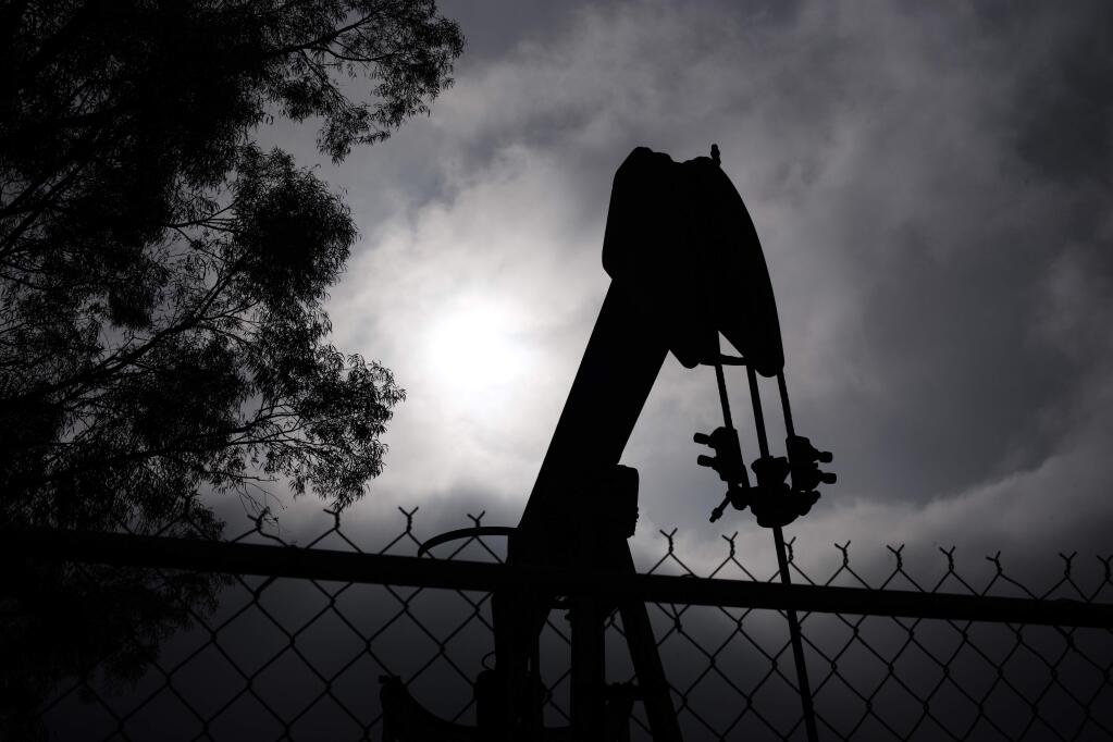 A pumpjack operates next to Tony Lemon's home, Thursday, Jan. 15, 2015, in Bakersfield, Calif. Lemon and other neighbors living around the idled well said they had been told nothing of any threat to local water. But Lemon said he trusted oil companies to safeguard the public water supply. As long as they know what theyre doing, taking care of business, Lemon said. (AP Photo/Jae C. Hong)