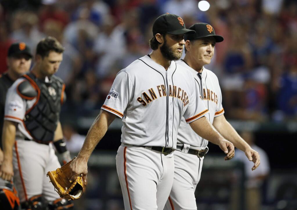 San Francisco Giants starting pitcher Madison Bumgarner is escorted back to the dugout after a heated exchange between Bumgarner and members of the Texas Rangers in the fourth inning of a game Friday, July 31, 2015, in Arlington, Texas. Both benches cleared and met on the field but promptly returned to their respective dugouts. (AP Photo/Tony Gutierrez)