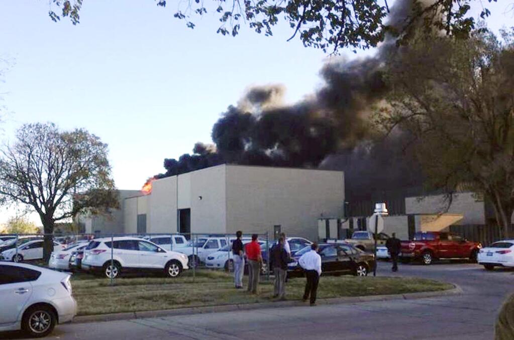 In the image from video provided by KAKE News black smoke billows from a building at Mid-Continent Airport where officials say a plane crashed Thursday, Oct. 30, 2014 in Wichita, Kan. AP Photo/KAKE News)