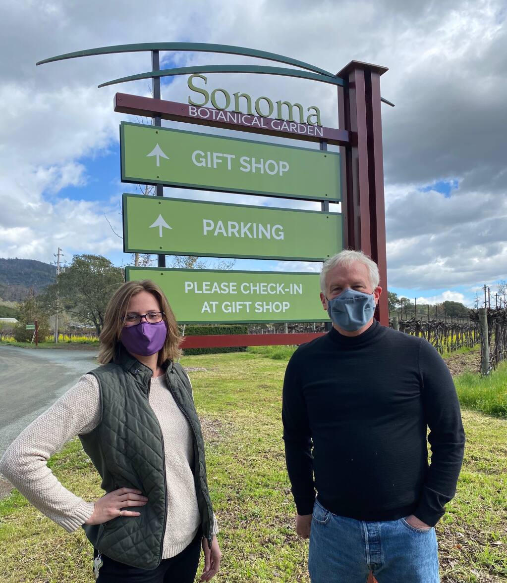 Kate Rabuck, curator of education and exhibitions, and Scot Medbury, director, show the Sonoma Botanical Garden’s new sign. (Sonoma Botanical Garden)