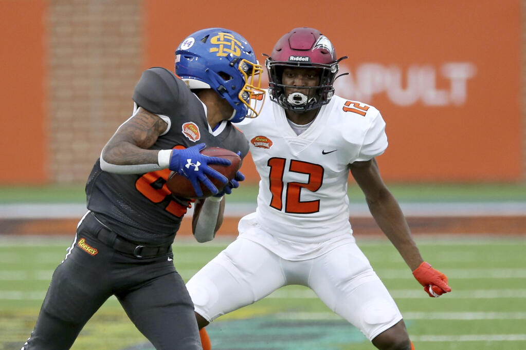 Wide receiver Cade Johnson of South Dakota State, left, runs the ball as defensive back Bryan Mills of North Carolina Central defends during the second half of the Senior Bowl in Mobile, Alabama, on Saturday, Jan. 30, 2021. (Rusty Costanza / ASSOCIATED PRESS)