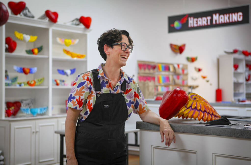 Artist Tracy Ferron, founder of Life on Earth Art, stands in the downtown showroom at 120 Petaluma Boulevard North where the touring exhibit featuring papier-maché hearts of all sizes can be viewed until the end of October. (CRISSY PASCUAL/ARGUS-COURIER STAFF).