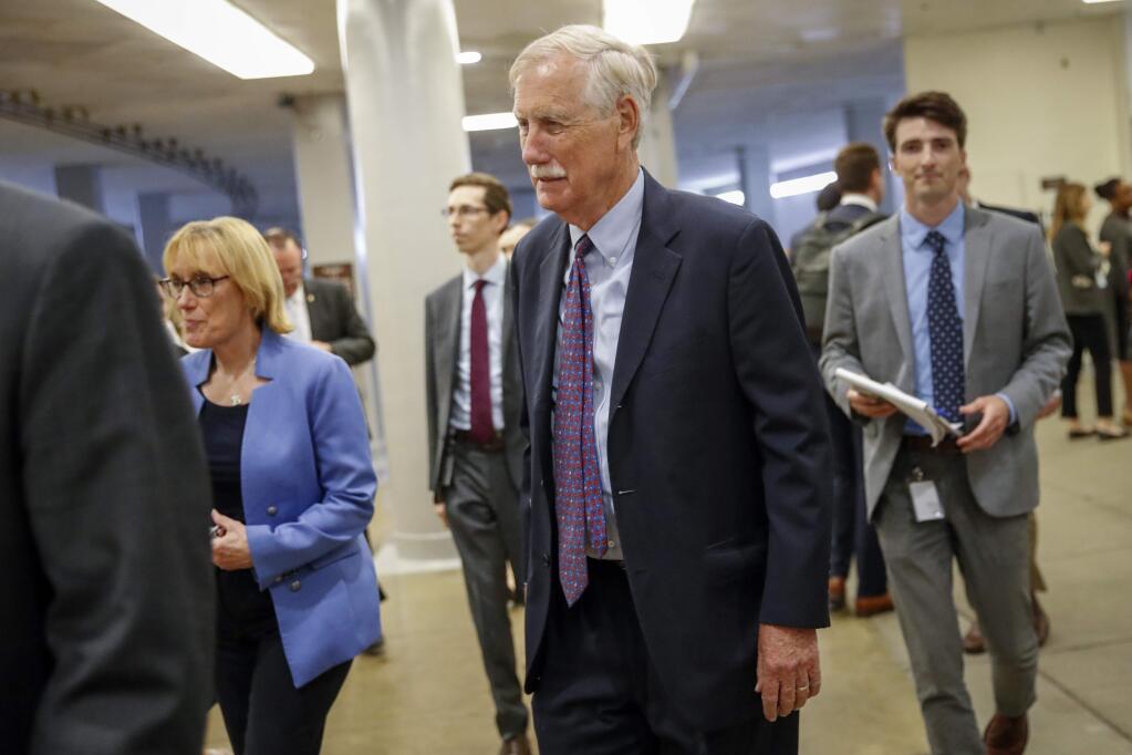 Sen. Angus King, I-Maine, center, with Sen. Maggie Hassan, D-N.H., left, walks to the Senate chamber for votes on federal judges as a massive budget pact between House Speaker Nancy Pelosi and President Donald Trump is facing a key vote in the GOP-held Senate later, at the Capitol in Washington, Wednesday, July 31, 2019. (AP Photo/J. Scott Applewhite)