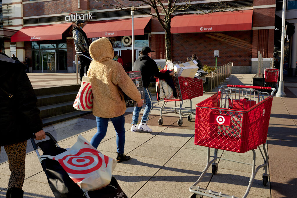 Shoppers outside a Target store in Brooklyn on March 26, 2022. The rapid rebound in consumer spending has overwhelmed supply chains, driving up prices. (Gabby Jones / The New York Times)