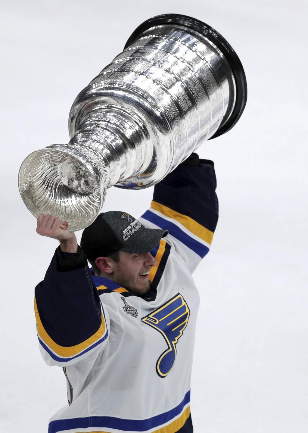 St. Louis Blues goaltender Jordan Binnington carries the Stanley Cup after the Blues defeated the Boston Bruins in Game 7 of the NHL Stanley Cup Final, Wednesday, June 12, 2019, in Boston. (AP Photo/Charles Krupa)