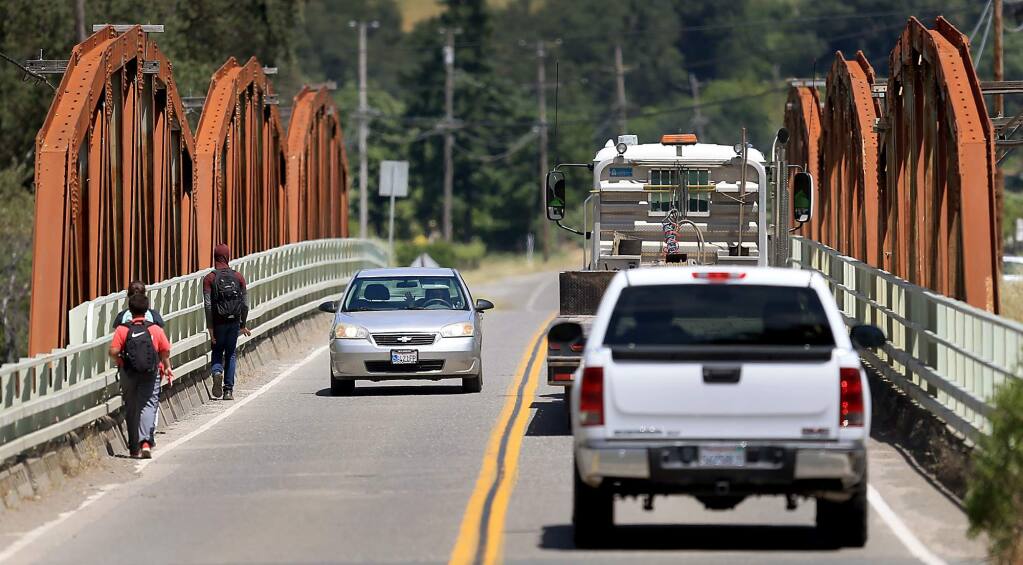 School children hug the guard rail on the Crocker Road bridge over the Russian River in Cloverdale, Wednesday May 10, 2017. The Sonoma County Transportation Authority is spending $26 million on 22 transportation projects, including a much needed bike and pedestrian path over the bridge. (Kent Porter / The Press Democrat) 2016