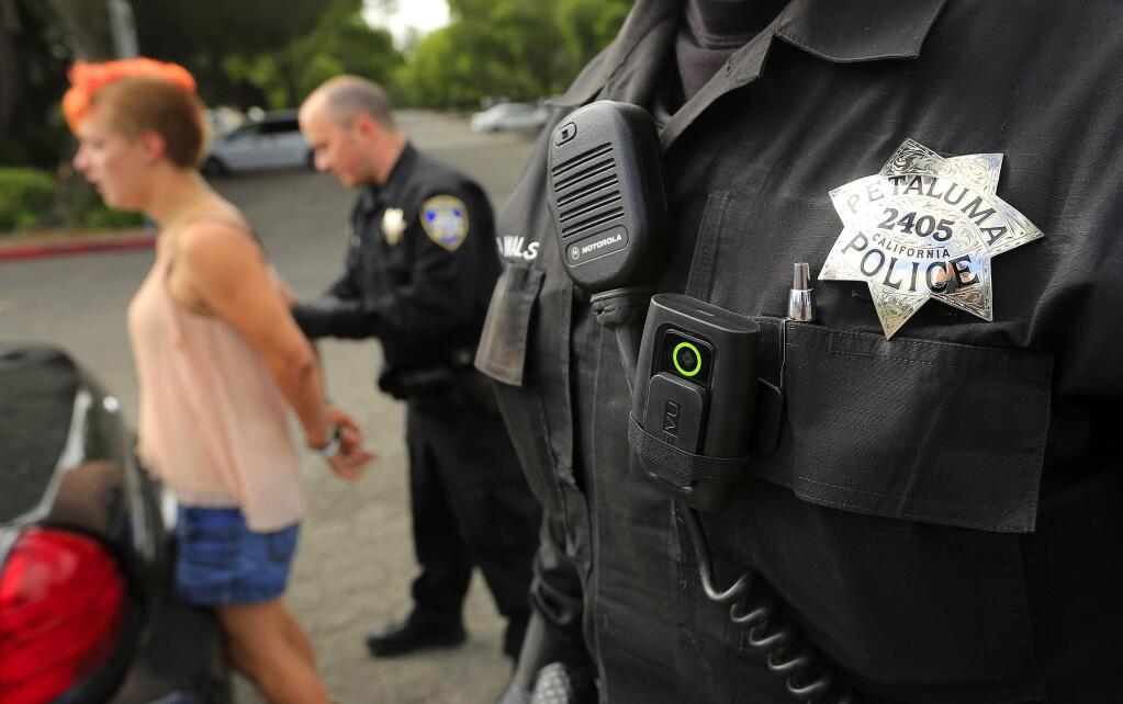 Petaluma Police Sgt. Jeremy Walsh uses a small body camera during a stop for a suspected assault. (JOHN BURGESS / The Press Democrat)
