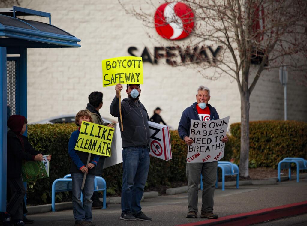 A group of protestors marched around the shopping center on McDowell Boulevard and Washington where the Safeway is located and has proposed opening a gas station there.(CRISSY PASCUAL/ARGUS-COURIER STAFF)