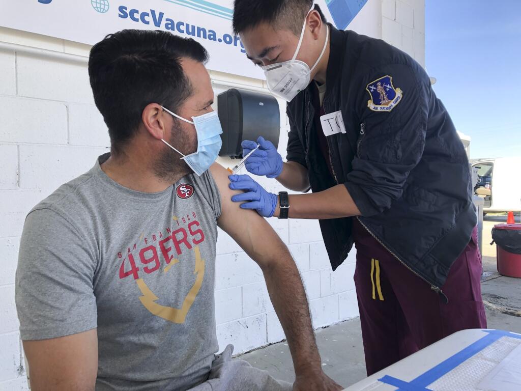 Mauricio Chavez of Hollister gets a COVID-19 vaccine at Monterey Mushrooms in Morgan Hill on Feb. 28, 2021. He works at a neighboring mushroom farm. Many California farmworkers still face obstacles getting the vaccine. (Ana Ibarra / CalMatters)