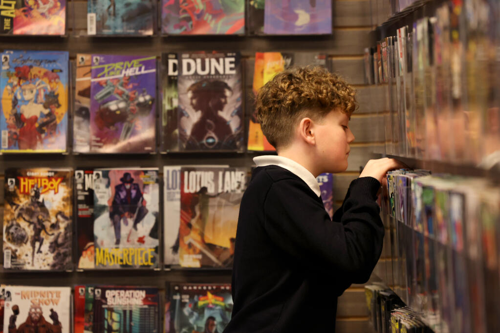 Collin Rice, 13, looks through issues of “The Punisher” comic book series for sale at Zeppelin Comics in Napa, Wednesday, Jan. 31, 2024. (Beth Schlanker / The Press Democrat)