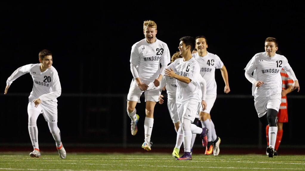 Windsor's Olin Piotter, second from left, celebrates with his teammates after he scored a goal with a header off a corner kick during the first half on Wednesday, February 1, 2017. (Alvin Jornada / The Press Democrat)