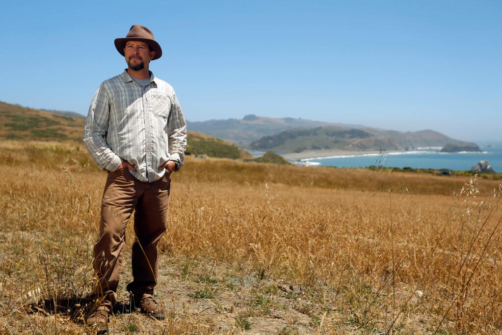 The Wildlands Conservancy regional director of Sonoma Coast Preserves Brook Edwards poses for a portrait at the Jenner Headlands Preserve, with a view of Goat Rock State Beach in the distance, in Jenner, California, on Friday, June 29, 2018. (Alvin Jornada / The Press Democrat)