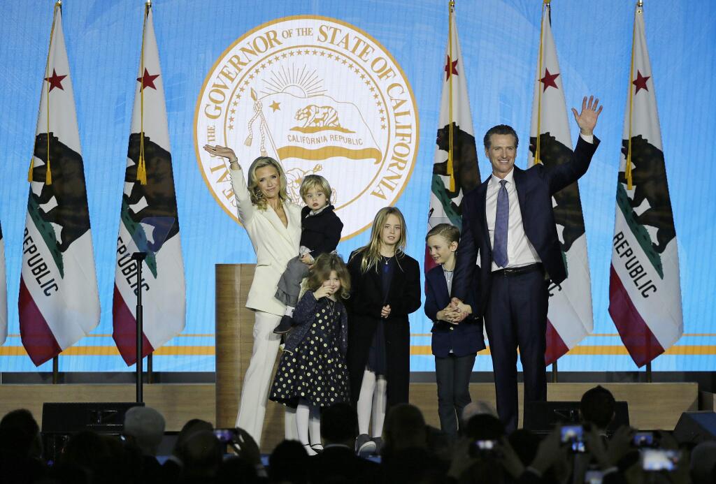 California Governor Gavin Newsom waves with his wife Jennifer Siebel Newsom and his children following his inauguration Monday, Jan. 7, 2019, in Sacramento, Calif. The children from left are Dutch, Brookyn, Montana and Hunter. (AP Photo/Eric Risberg)