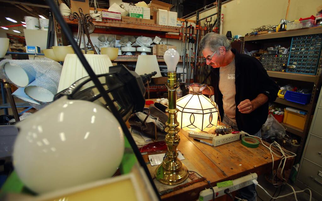 Volunteer Harold Minkin repairs donated lights at ReStore, a used home improvement store with proceeds going to Habitat For Humanity of Sonoma County. (photo by John Burgess/The Press Democrat)