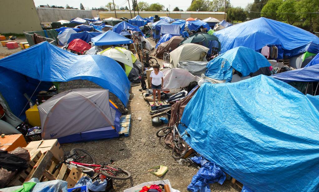 The sprawling homeless encampment behind the Dollar Tree store in Roseland where homeless advocates have sued to block the clean out of the camp. (Photo by John Burgess/The Press Democrat)
