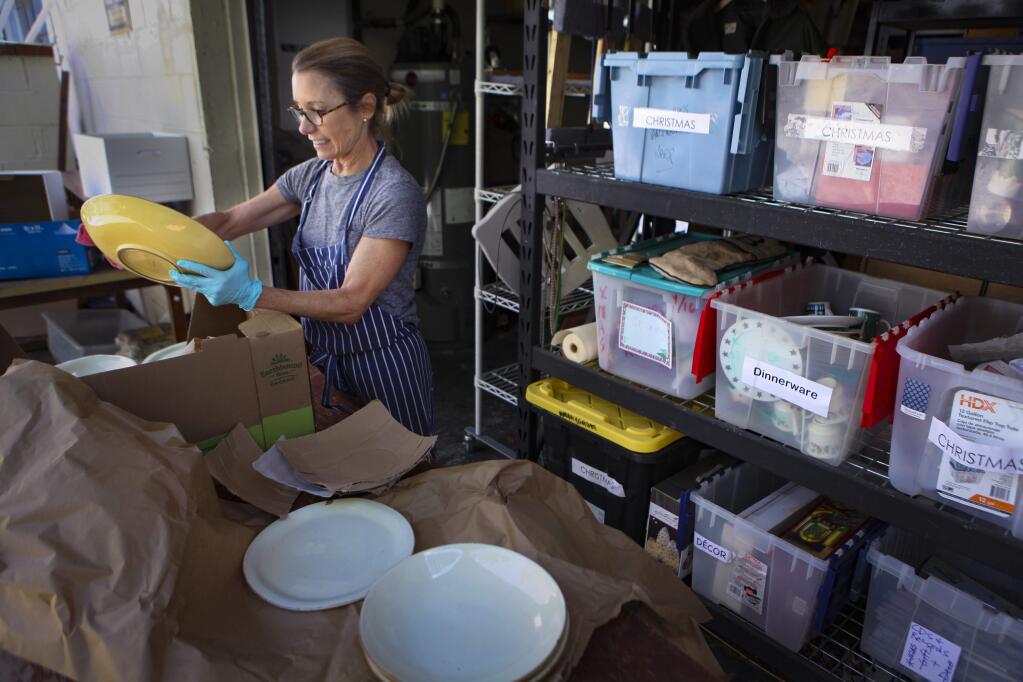 Petaluma, CA, USA, Thursday, May 21, 2020._Mary Haller, the Home Store Lead at the Alphabet Soup thrift store in downtown Petaluma, cleans items that were recently donated. (CRISSY PASCUAL/ARGUS-COURIER STAFF)
