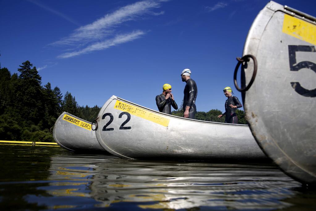 (From left) David Welby of Santa Monica, Cameron Good of Sydney, Australia, and Holly Lawrence, of Somerset, England, practice for the upcoming IRONMAN 70.3 Vineman. Photo taken at Johnson's Beach in Guerneville, on Friday, July 8, 2016. (BETH SCHLANKER/ The Press Democrat)