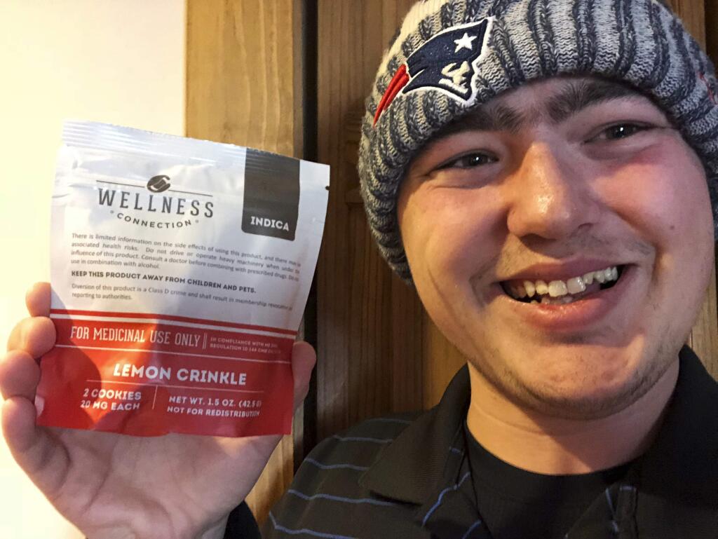 This Jan. 10, 2018, photo provided by Zac Mercauto shows him holding a package of marijuana cookies in Fryeburg, Maine. Mercauto is one of many proponents of legalized marijuana who supports President Donald Trump, but thinks his administration is wrong about its anti-pot stance. (Zac Mercauto via AP)
