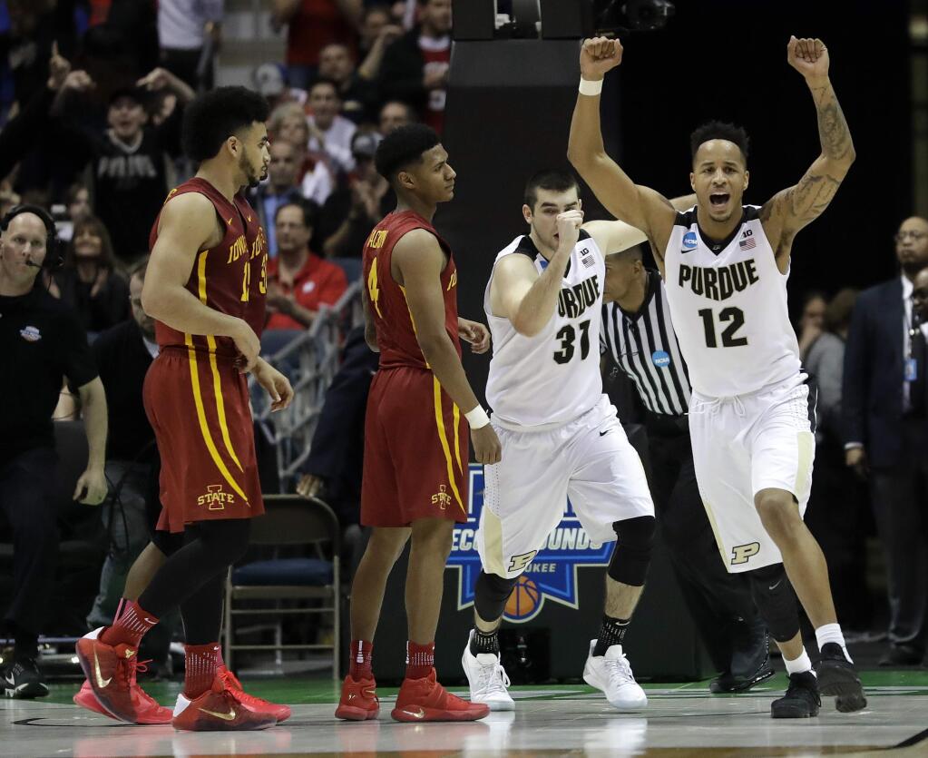 Purdue's Vince Edwards (12) and Dakota Mathias (31) celebrate after defeating Iowa State 80-76 in an NCAA college basketball tournament second-round game Saturday, March 18, 2017, in Milwaukee. (AP Photo/Morry Gash)