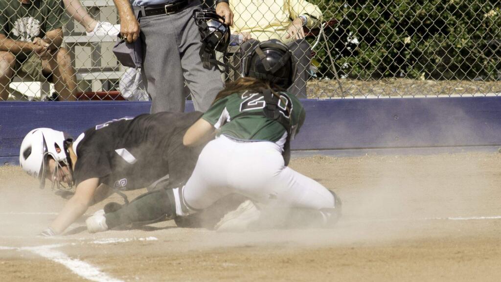RICH LANGDON/FOR THE ARGUS-COURIERPetaluma's Emily Croda is safe at home as she slides into Sonoma Valley catcher Beverly Harris in the SCL Tournament championship game won by Sonoma, 10-9.