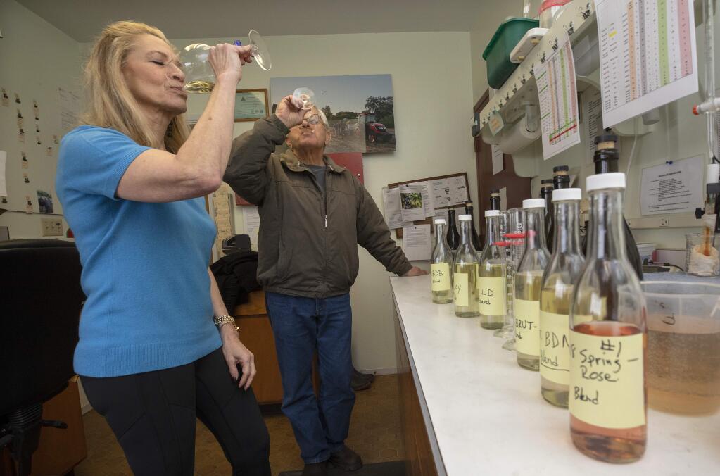 Iron Horse Vineyards CEO Joy Sterling, left, and winemaker David Munksgard taste 2018 base wines for blending into their line of sparkling wines. (photo by John Burgess/The Press Democrat)
