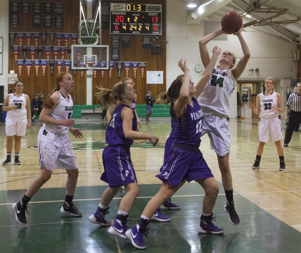 LADY DRAGONS command the ball in this shot from a recent game against Petaluma. Kayla Field (at left, 5) and Renee O'Donnell (24) were big influences in recent win against Healdsburg. (Robbi Pengelly/Index-Tribune)