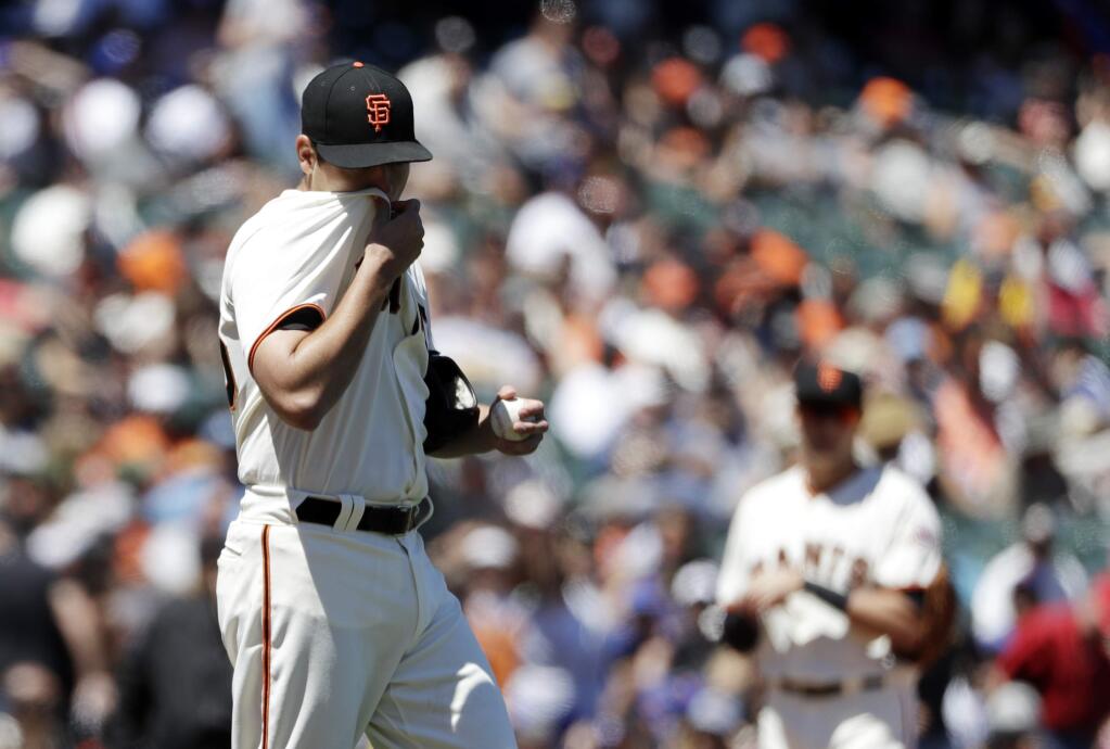 San Francisco Giants starting pitcher Matt Moore, left, stands on the mound after giving up an RBI-double to the New York Mets' Lucas Duda during the fifth inning Sunday, June 25, 2017, in San Francisco. (AP Photo/Marcio Jose Sanchez)