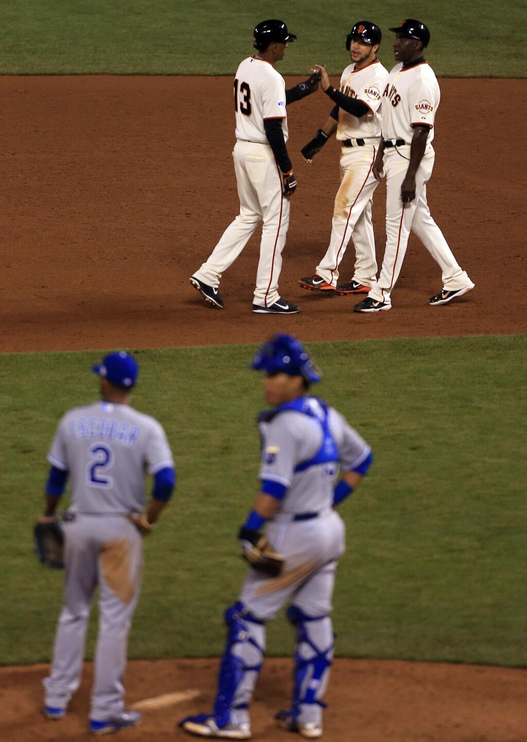 Joaquin Arias, left Gregor Blanco and first base coach Roberto Kelly during a replay call during game 4 of the World Series in San Francisco, Saturday Oct. 25, 2014. (Kent Porter / Press Democrat) 2014