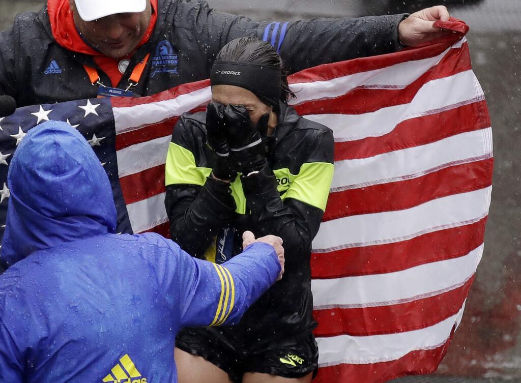 Desiree Linden, of Washington, Mich., celebrates after winning the women's division of the 122nd Boston Marathon on Monday, April 16, 2018, in Boston. She is the first American woman to win the race since 1985. (AP Photo/Charles Krupa)