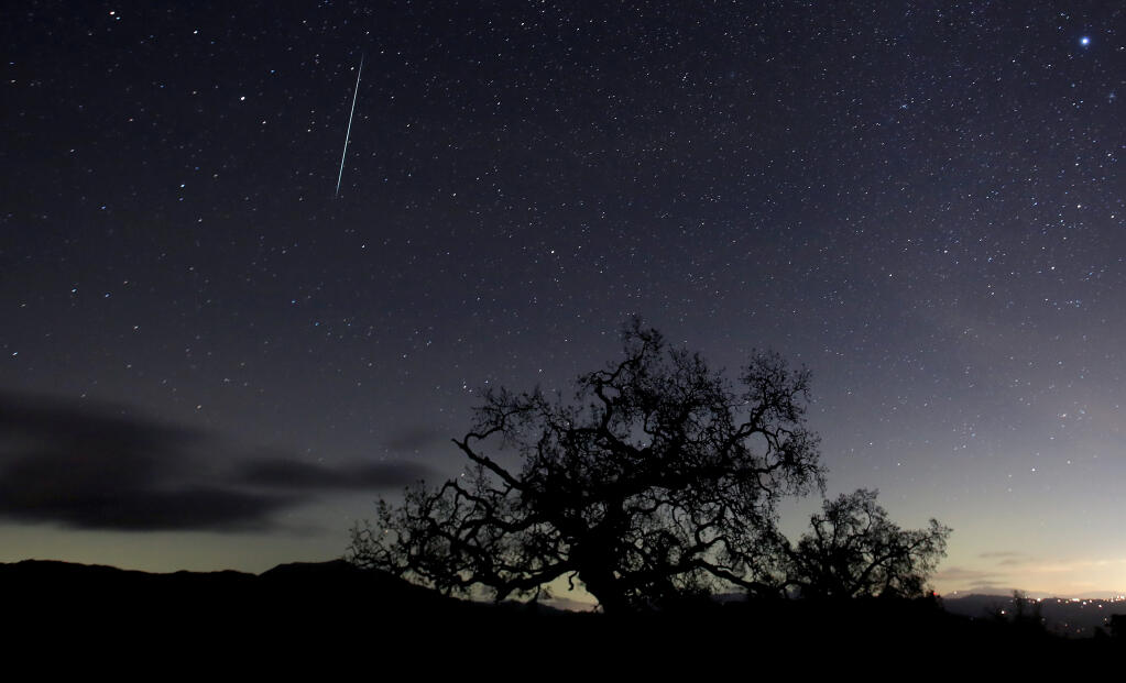 A meteor leaves a trail above the Geysers area of Sonoma County, Monday, Dec. 14, 2020.  The Tau Herculid meteor shower might be visible to sky watchers at night on the Memorial Day holiday.   (Kent Porter / The Press Democrat) 2020