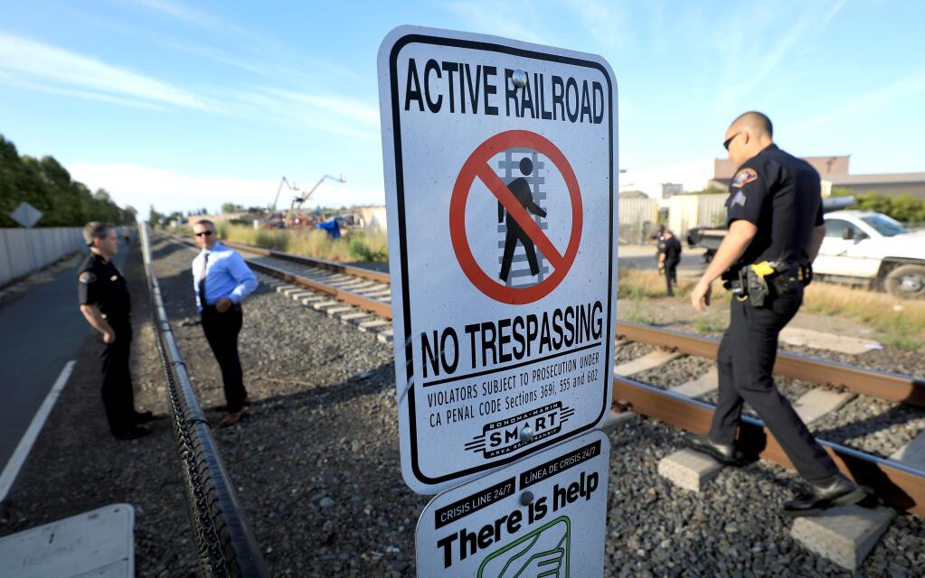 Rohnert Park public safety officers document the scene of SMART train vs bicyclist fatality at Golf Course Drive in Rohnert Park on Friday. It was the second train fatality in as many days at the same location. (KENT PORTER / The Press Democrat, 2018)