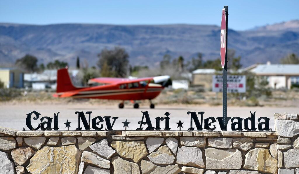 A small single-engine plane is parked just outside the Cal-Nev-Ari Casino on Thursday, Feb. 25, 2016, in Cal-Nev-Ari, Nev. Nancy Kidwell is offering the entirety of her town for just $8 million. She tried to sell the property in 2010 for $17 million but couldn't find any buyers. Now the 78-year-old has dropped the price and is including Cal-Nev-Ari's casino, diner, convenience store, 10-room motel, RV park and mile-long dirt airstrip in the deal. (David Becker/Las Vegas Review-Journal via AP)