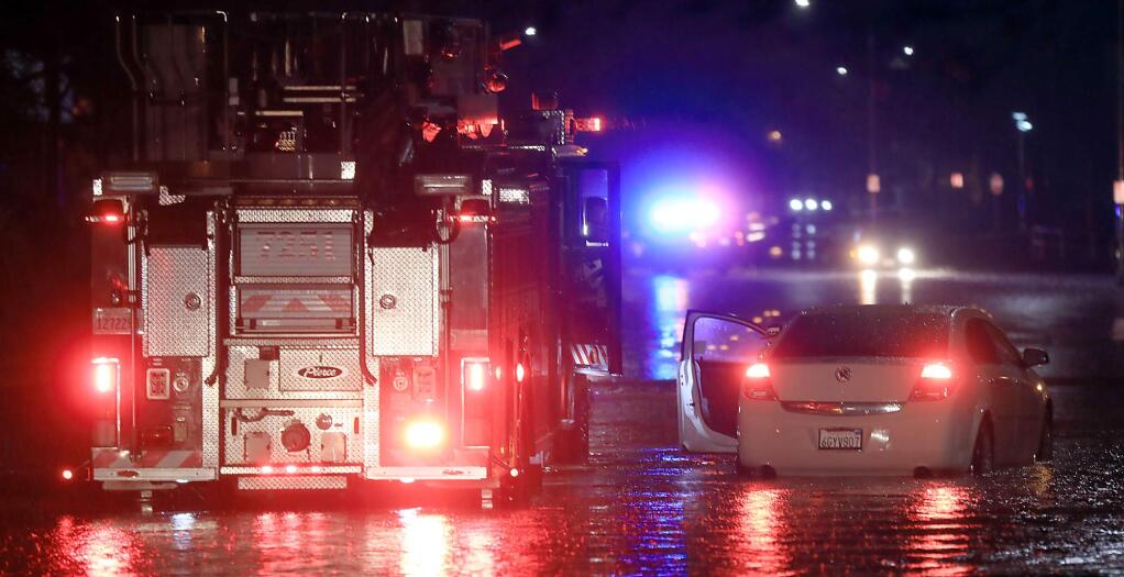 Windsor firefighters stop to pick up people that were stranded in high water on Skyline Blvd. in Windsor, Wednesday Feb. 13, 2019, due to heavy overnight rain. (Kent Porter / The Press Democrat) 2019
