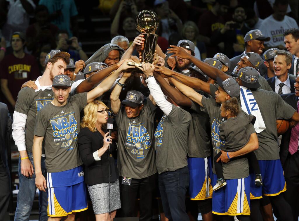 The members of the Golden State Warriors celebrate after winning the NBA Finals against the Cleveland Cavaliers in Cleveland, Wednesday, June 17, 2015. The Warriors defeated the Cavaliers 105-97 to win the best-of-seven game series 4-2. (AP Photo/Paul Sancya)