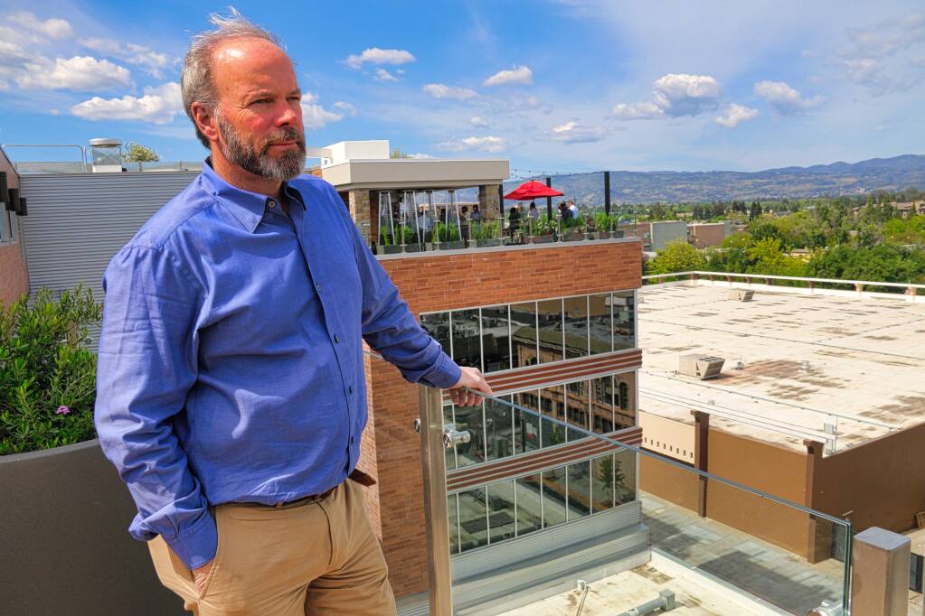 Todd Zapolski, head of the First Street Napa mixed-use development in downtown Napa, shows the view to the north in Napa Valley from the roof of the Archer hotel. Also visible is the rooftop lounge and the Kohl's department store, a property Zapolski Real Estate also controls. (JEFF QUACKENBUSH / NORTH BAY BUSINESS JOURNAL) May 1, 2018