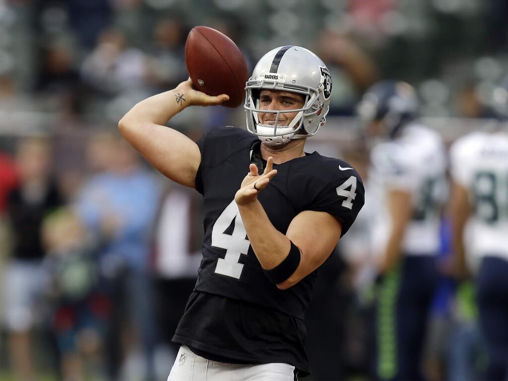In this Sept. 1, 2016, file photo, Oakland Raiders quarterback Derek Carr warms up before a preseason game against the Seattle Seahawks Thursday, Sept. 1, 2016, in Oakland. (AP Photo/Ben Margot, File)