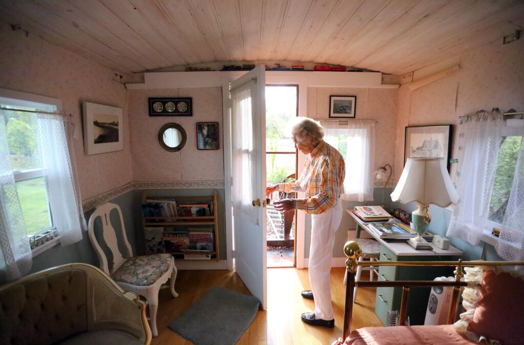 Sylvia Linde stands in her caboose that has been turned into a little getaway that includes sitting areas, a bed, kitchen and bathroom, Thursday, November 13, 2014. (Crista Jeremiason / The Press Democrat)