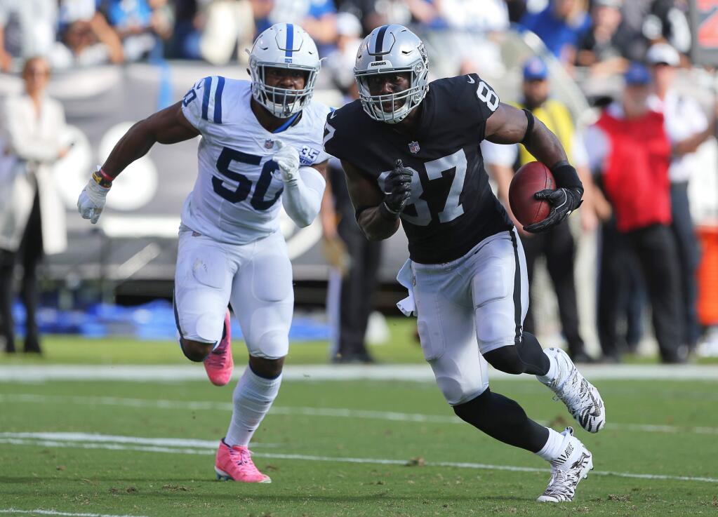 Oakland Raiders tight end Jared Cook runs away from Indianapolis Colts linebacker Anthony Walker, to score a touchdown during their game in Oakland on Sunday, October 28, 2018. The Colts defeated the Raiders 42-28.(Christopher Chung/ The Press Democrat)